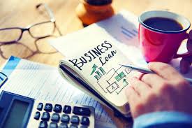 Business loan paper vbesides a calcular and coffee mug