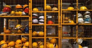 Builders' helmets are locked behind the bars.