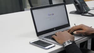 A man is using Google search on his laptop.